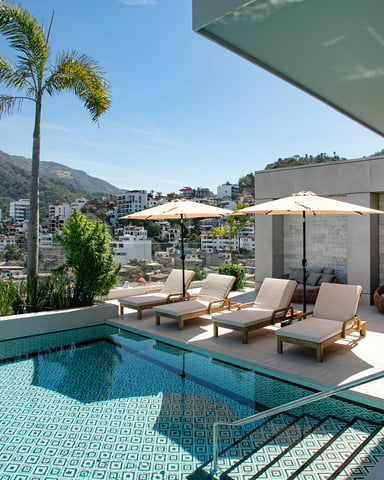 All-white terrace with lounge chairs under open sky